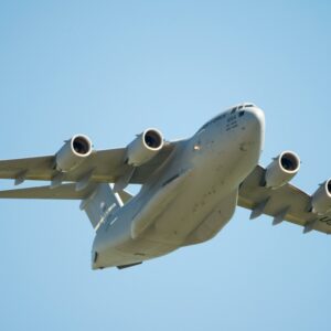 US Air Force C-17 Globemaster aircraft flying low in clear blue sky over Fairfield, California.