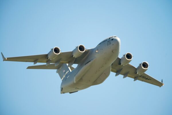 US Air Force C-17 Globemaster aircraft flying low in clear blue sky over Fairfield, California.